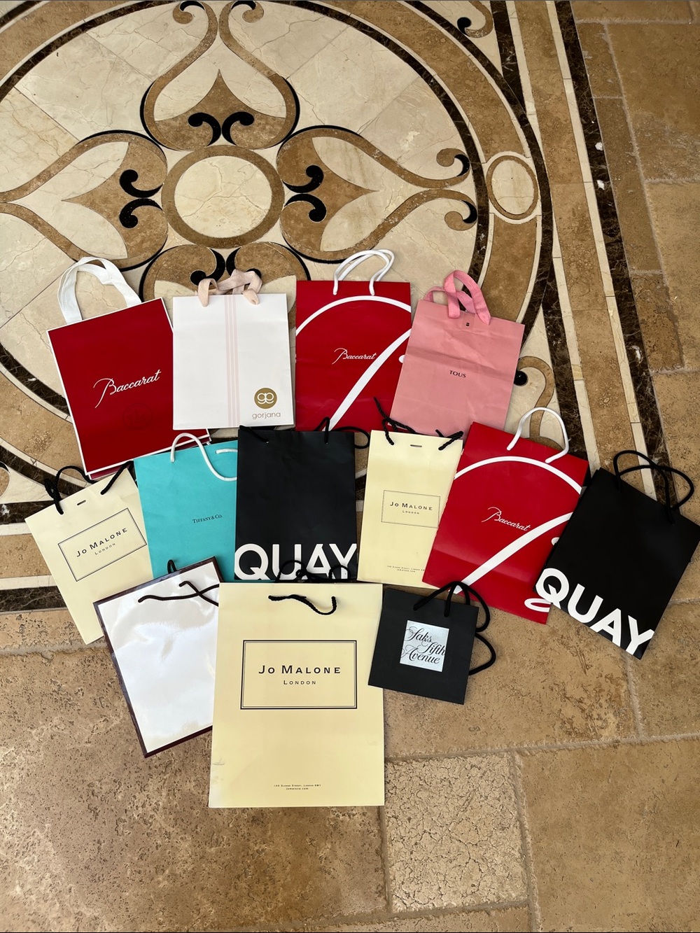 Tiffany & Co. blue shopping bag with assorted designer bags